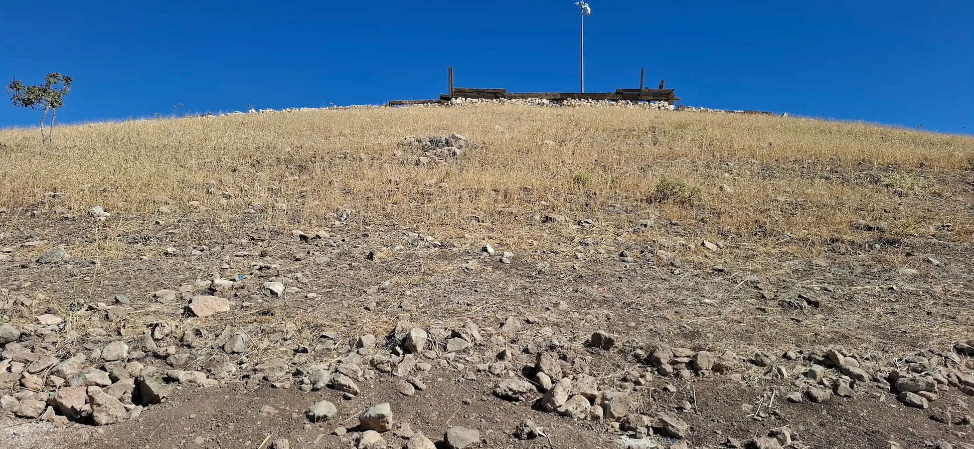 Wide landscape view of Göbeklitepe hilltop in Şanlıurfa Province, Turkey.